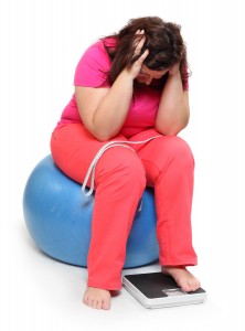 Overweight woman with weighing machine. Weight loss concept.