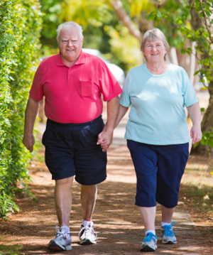 Active seniors walking and holding hands